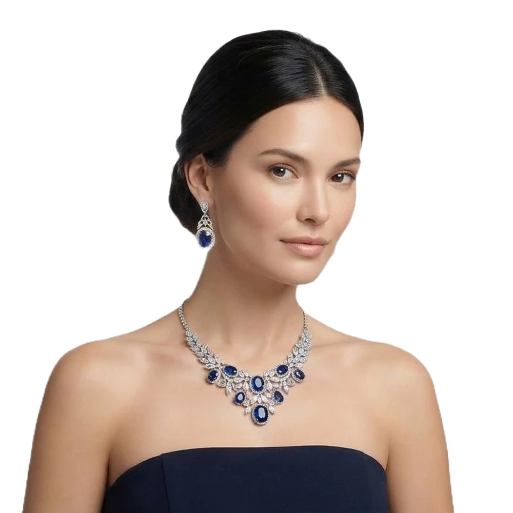 Model wearing a sapphire and diamond necklace with matching earrings
